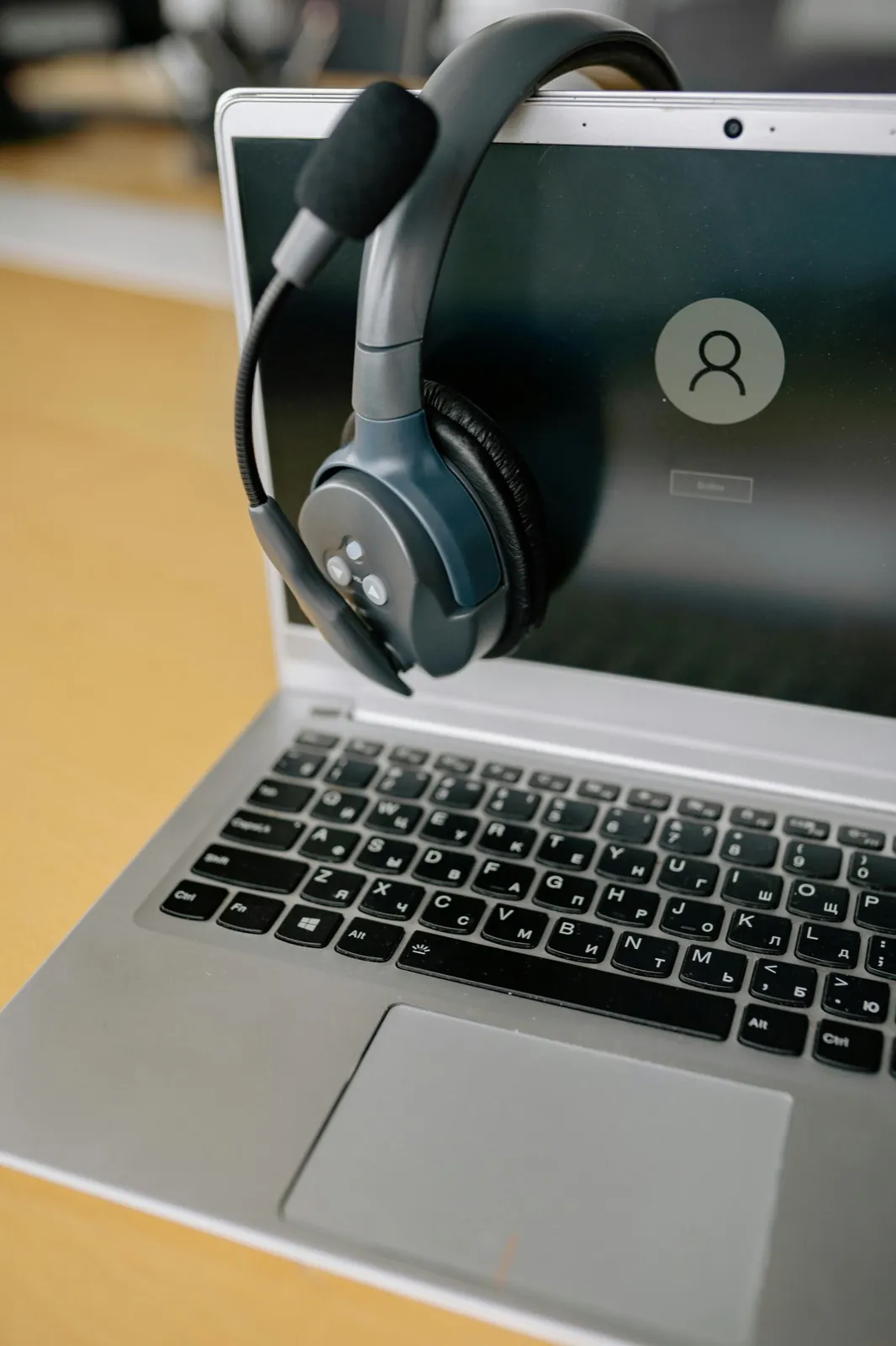 Headset resting on a laptop to represent automated IVR TPV workflows